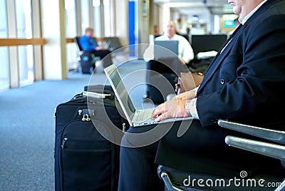 Business man on his laptop in the airport