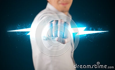 Business man holding glowing lightning bolt in his hands