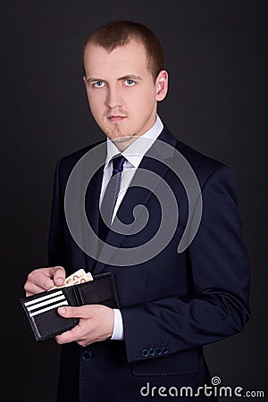 Business man holding leather purse with euro banknotes