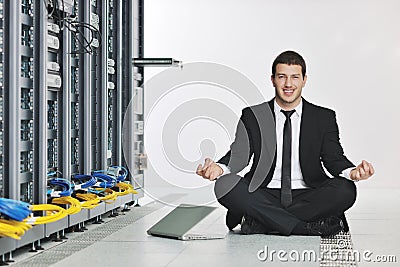 Business man practice yoga at network server room