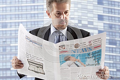 Business man reading a newspaper