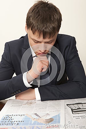 Business man reading a newspaper