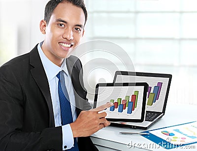 Business man showing tablet pc