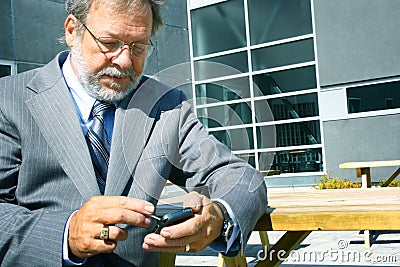 Business man using blackberry