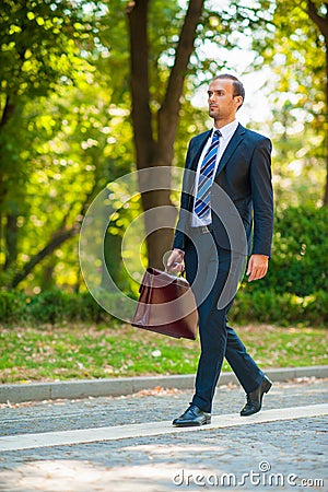 Business man walking in the park