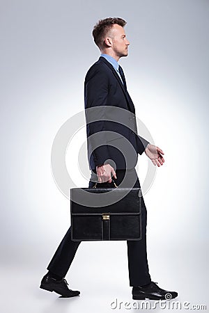 Business man walks with suitcase