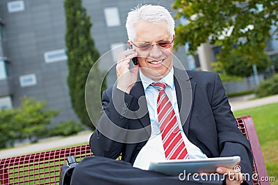 Business man working in park