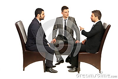 Business men on chairs having conversation