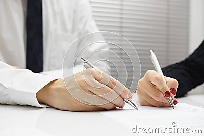 Business partners signing a document