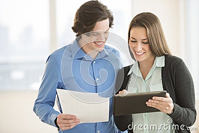 Business People Discussing Over Digital Tablet