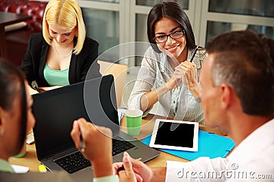 Business people having meeting around table