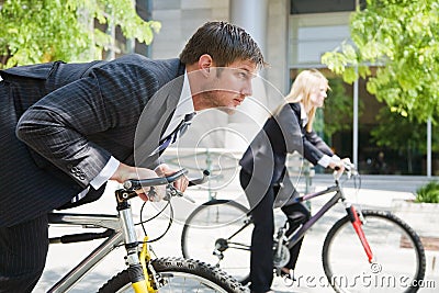 Business people racing on bicycles