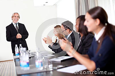 Business people sitting in a row at meeting