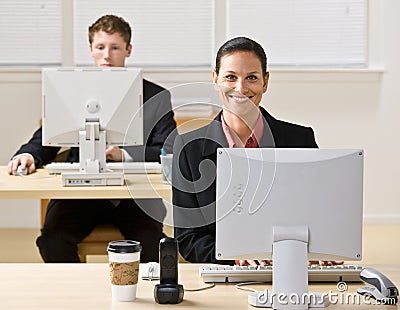 Business people typing on computers