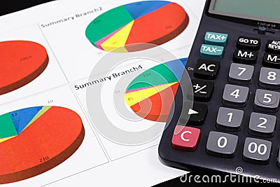 Business report graph with pen and calculator