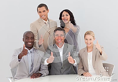 Business team celebrating a success with thumbs up