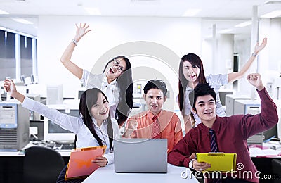 Business team cheering for success at office