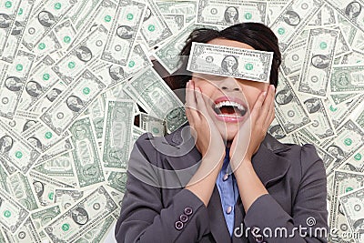 Business woman excited lying on money