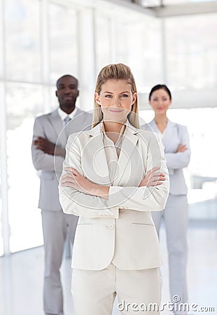 Business woman with folded arms with associates