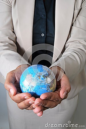 Business woman holding globe in her hands