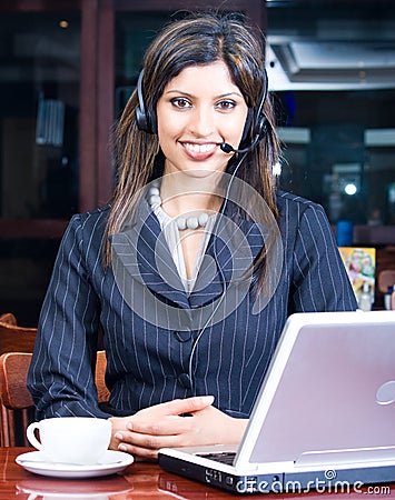 Business woman with laptop and headset