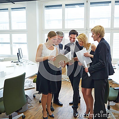 Business woman showing files to team