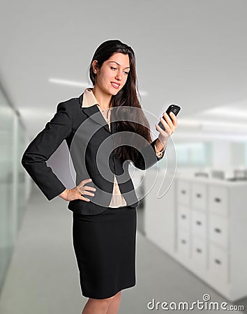 Business woman in suit on cell phone at office