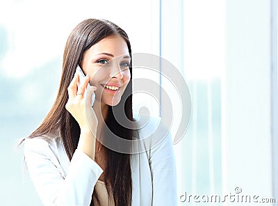 Business woman talking on cell phone while looking at copyspace
