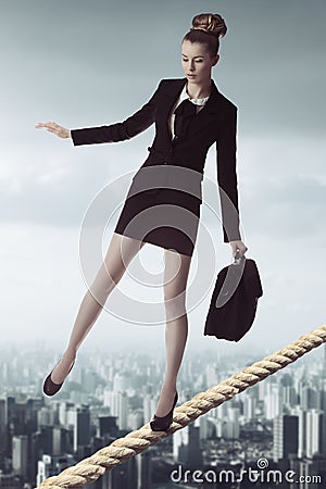 Business woman in unstable balance