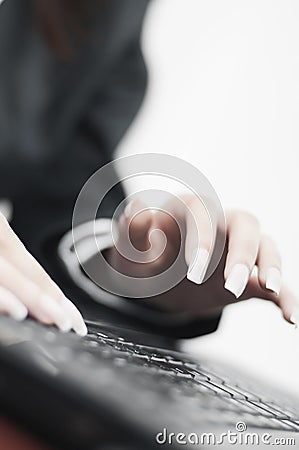 Business woman writing on laptop