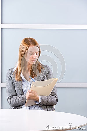 Business Woman Writing notes at desk