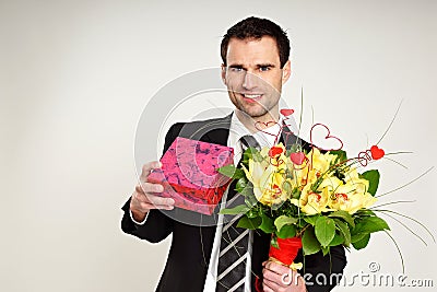 Businessman with bouquet and gift.