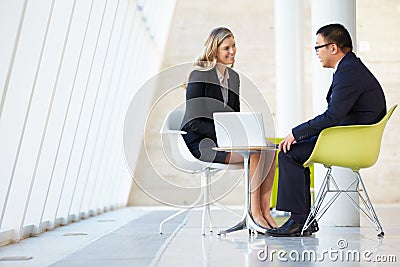 Businessman And Businesswoman Meeting In Modern Office