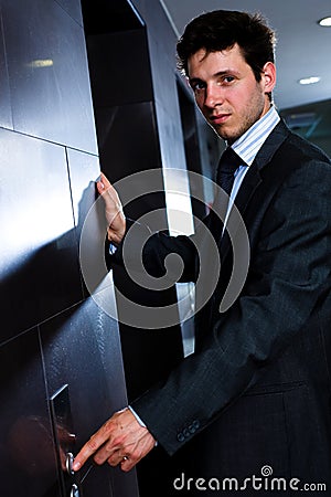 Businessman calling elevator