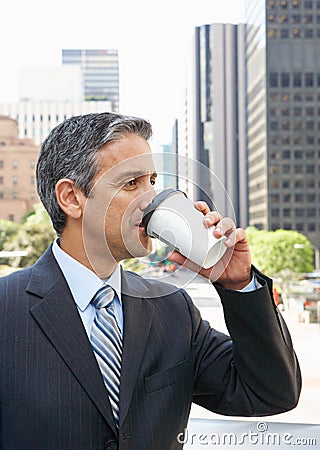 Businessman Drinking Takeaway Coffee Outside Office