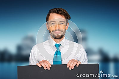 Businessman holding blank poster