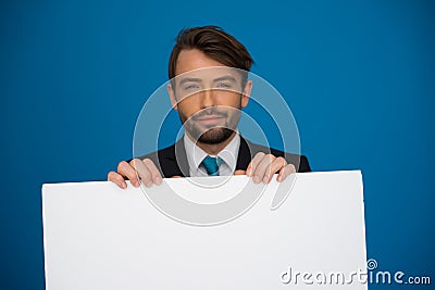 Businessman holding blank poster
