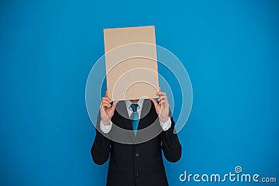 Businessman holding blank poster