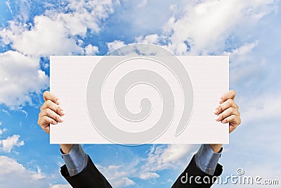 Businessman holding blank sign and hand in sky