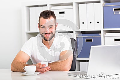 Businessman holding a cell phone and writing sms message