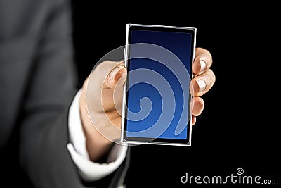 Businessman holding mobile phone with blue empty screen