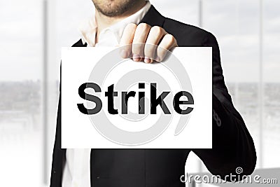 Businessman holding sign strike