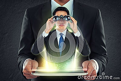 Businessman holding tablet pc and out man with binoculars