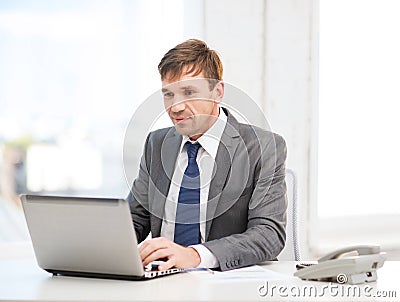 Businessman with laptop computer and documents