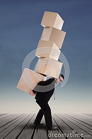 Businessman lifting boxes vertical