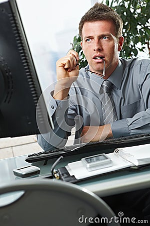 Businessman looking at screen in office