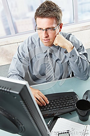 Businessman looking at screen in office