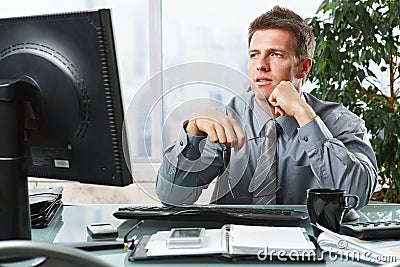 Businessman looking at screen in office