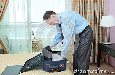 Businessman packing a suitcase