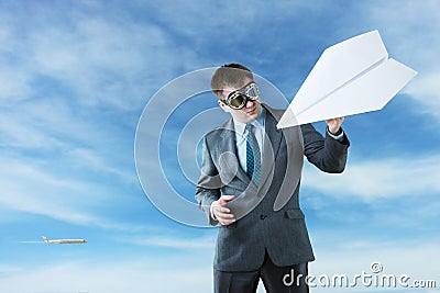 Businessman with paper plane and goggles